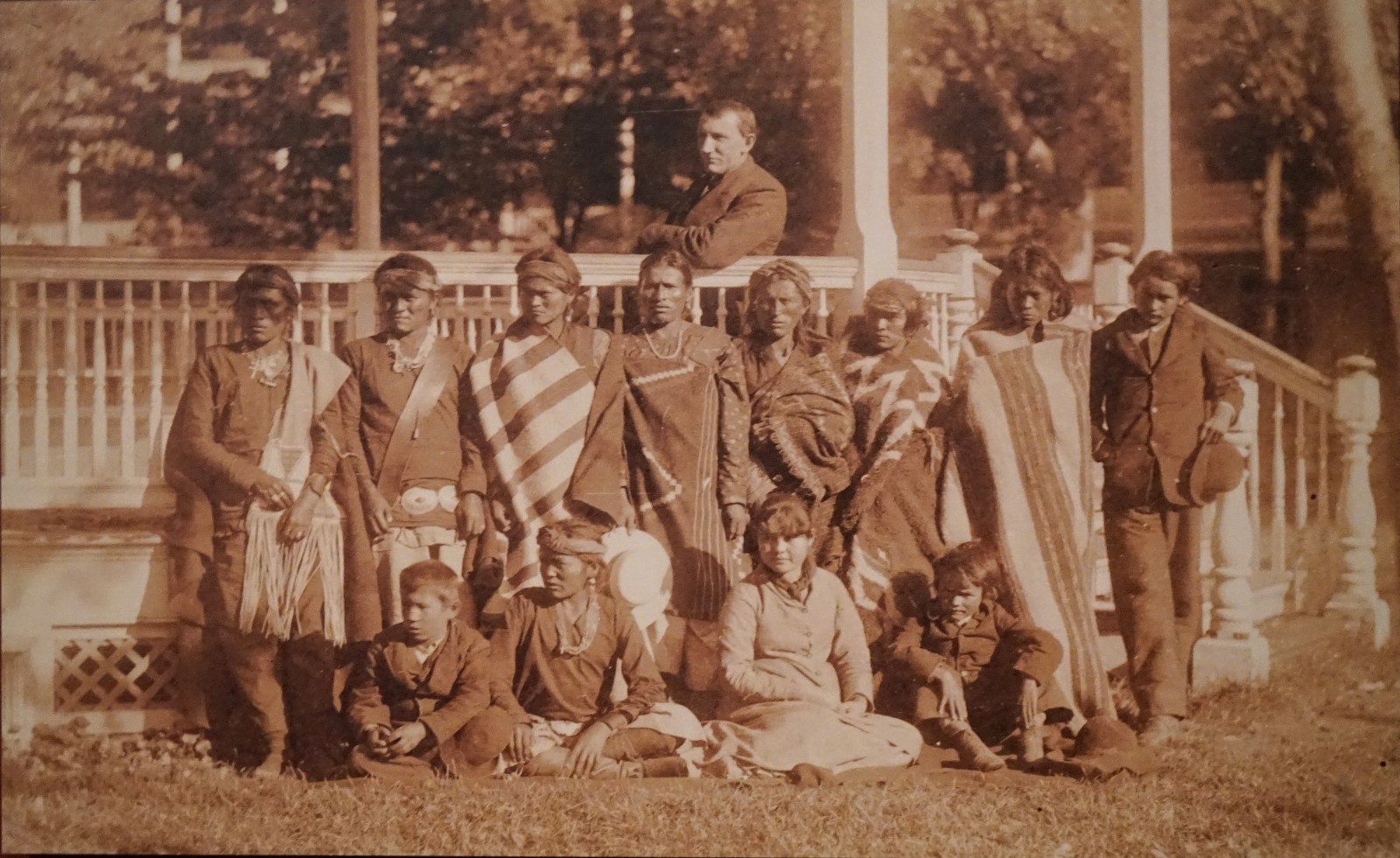 Capt Richard H. Pratt with Tom Torleno, Unidentified Girl And Group of Boys from New Mexico, Most in Native Dress, Upon Their Arrival Outside School Building.