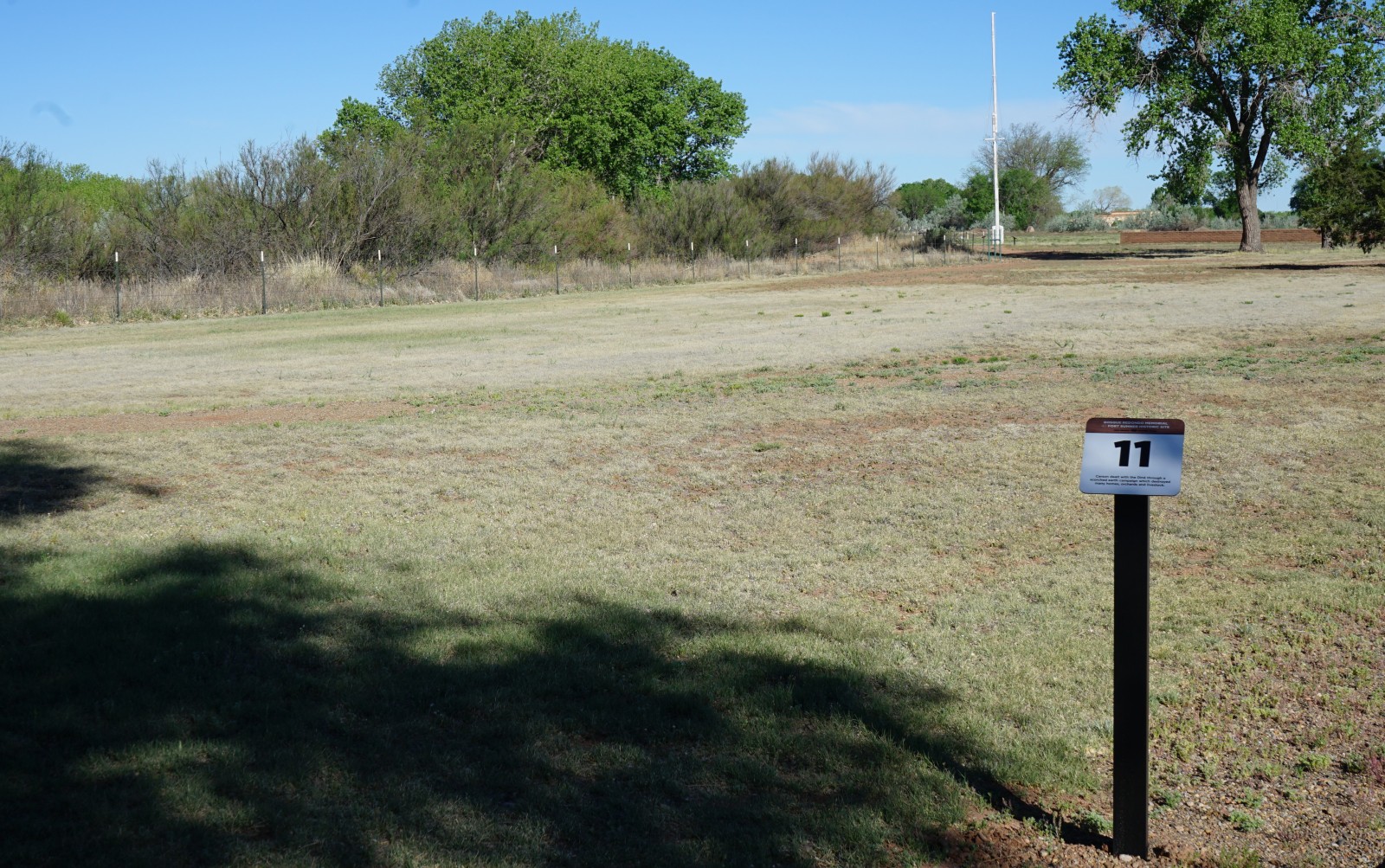 Bosque Redondo Memorial Audio Tour Stop 11, flag pole in the foreground.