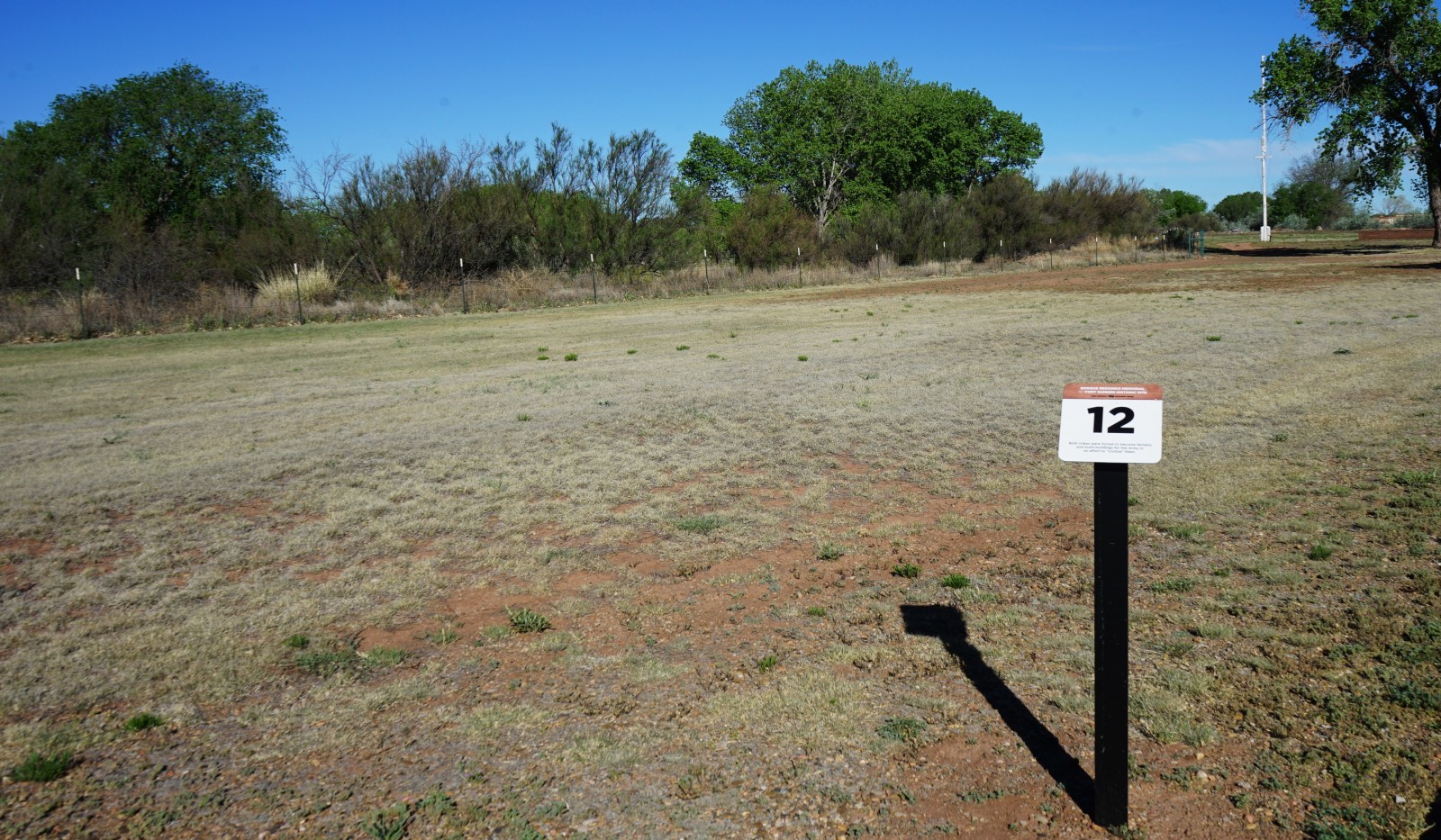 Bosque Redondo Memorial Audio Tour Stop 12, flag pole in the foreground.