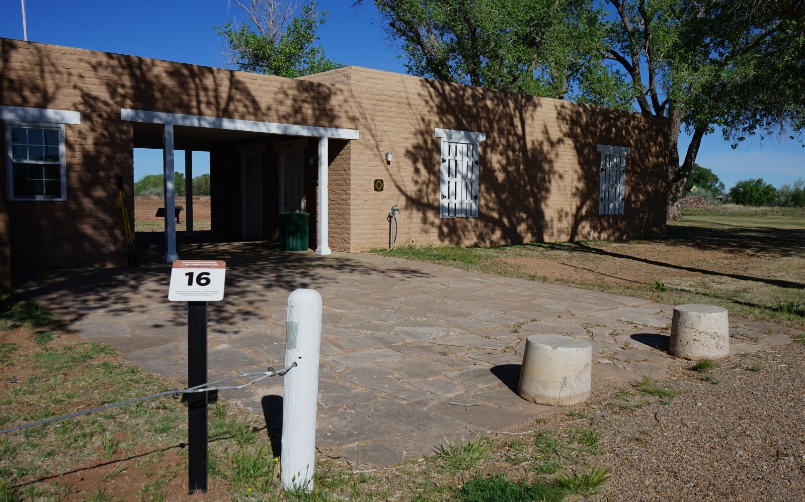 Bosque Redondo Memorial Audio Tour Stop 16 next to Site Barracks Exhibit entrance.