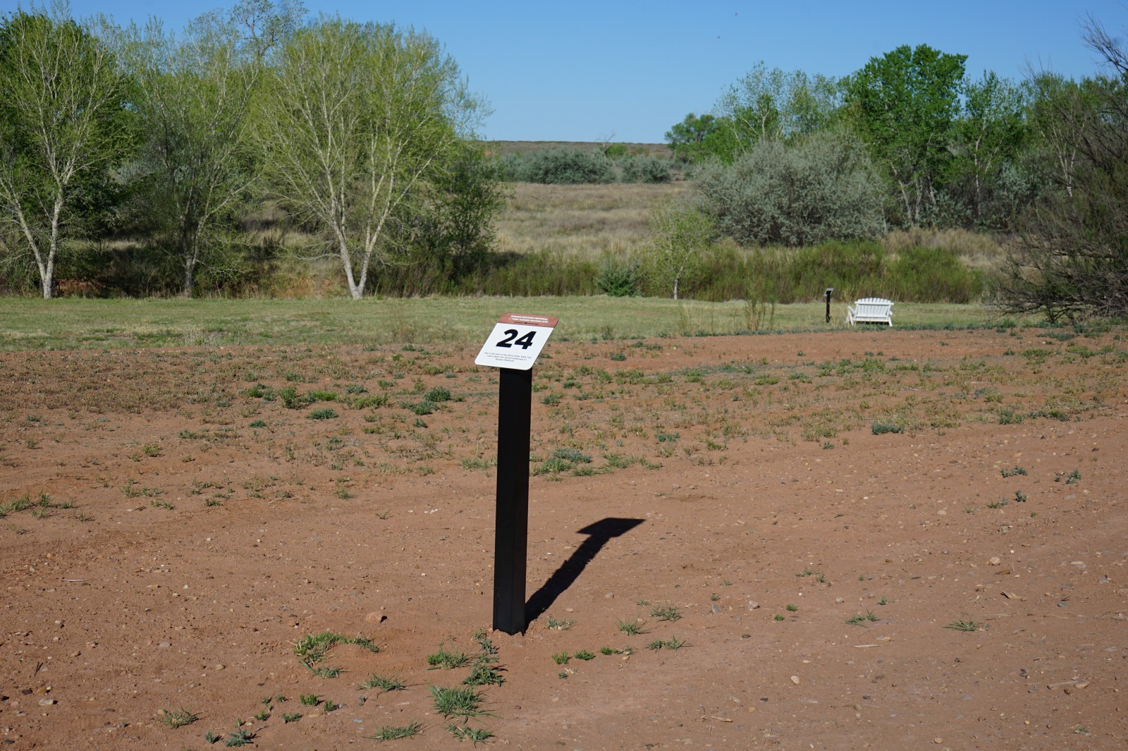 Bosque Redondo Memorial Audio Tour Stop 24 leading to lower nature trail tour, flood plain and trees in the foreground.